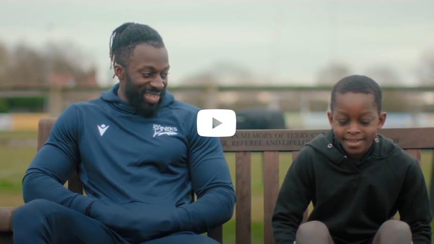 Man and boy talking on park bench