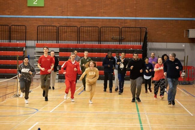 a group of people in a gym running in a race