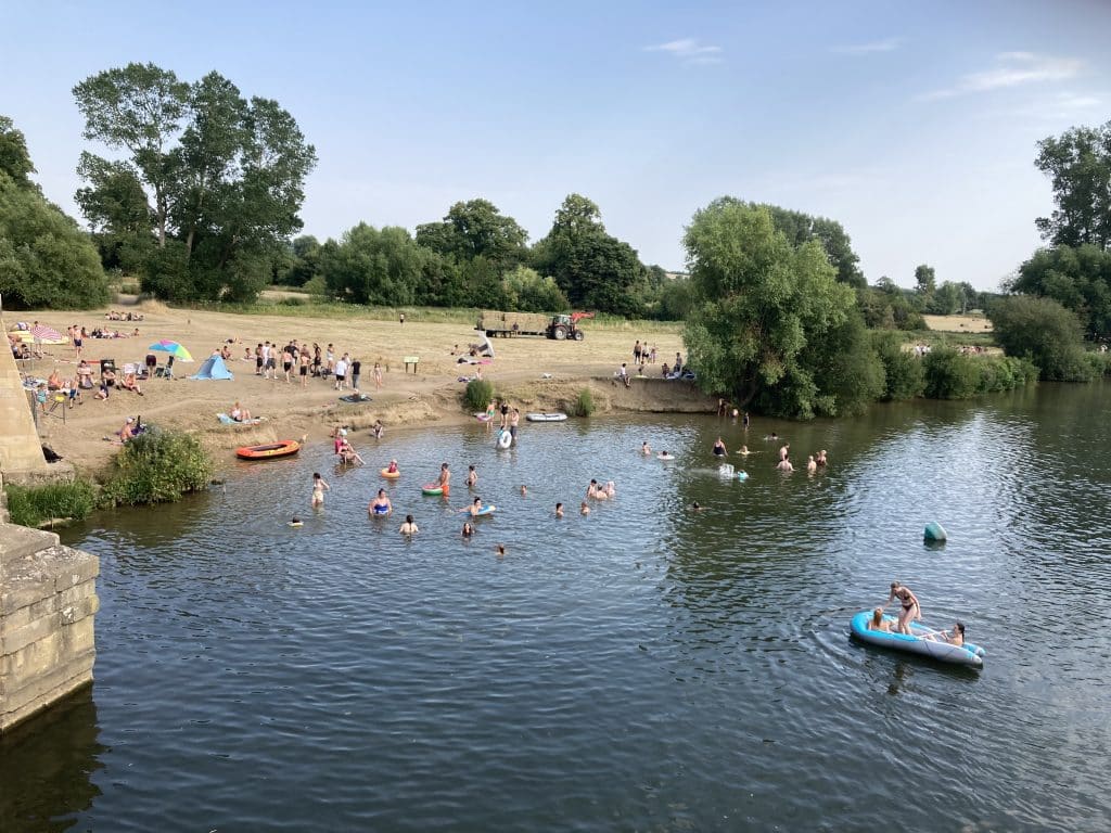 People enjoying recreational activities on the bank of the River Thames