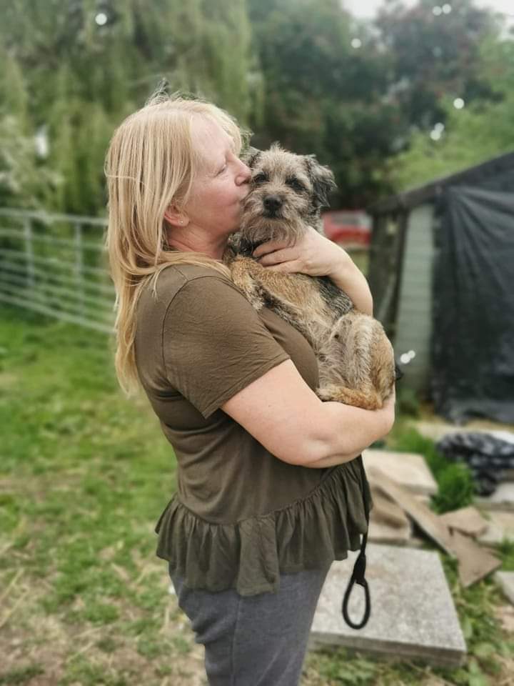 Lady cuddling a lovely dog