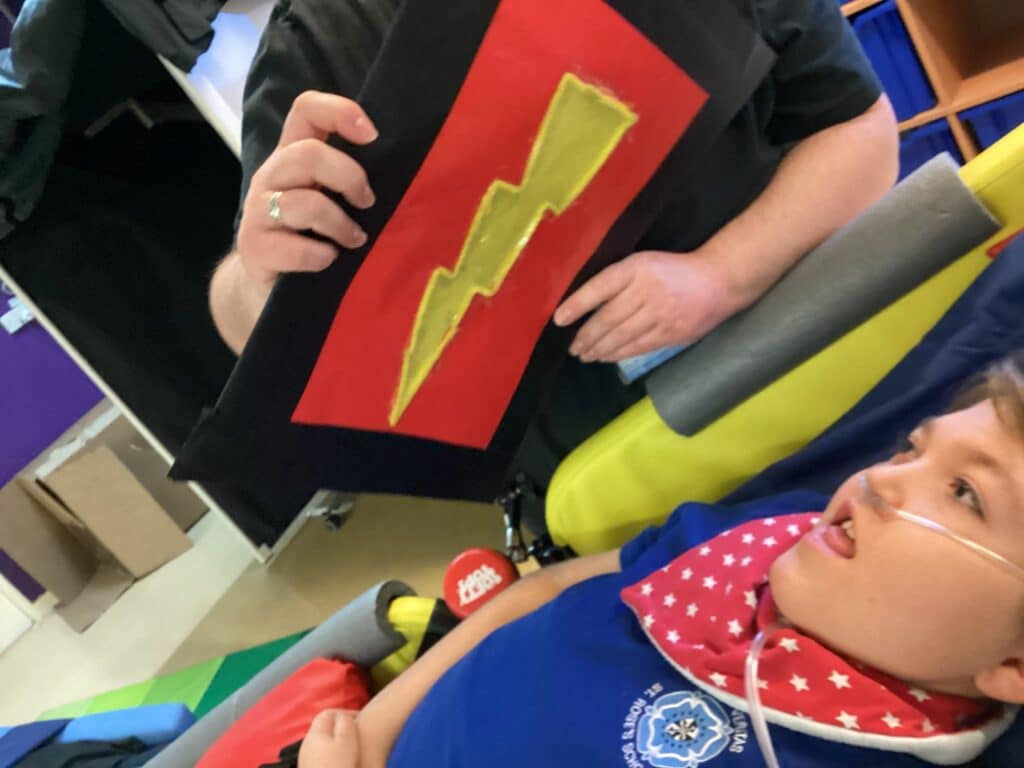 Child being shown lightening bulb picture